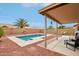 Private backyard oasis featuring a refreshing pool, covered patio, and desert landscaping at 10521 W Ross Ave, Peoria, AZ 85382