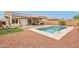 Resort-style backyard with sparkling pool, patio, solar panels, and desert landscaping at 10521 W Ross Ave, Peoria, AZ 85382