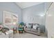 Bright bedroom showcasing cozy seating area with natural light and neutral color scheme at 10521 W Ross Ave, Peoria, AZ 85382
