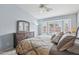 Large primary bedroom with bay window overlooking pool; featuring a dark wood dresser at 10521 W Ross Ave, Peoria, AZ 85382