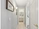 Hallway featuring tile floors leading to a bathroom with a white sink and vanity at 10521 W Ross Ave, Peoria, AZ 85382