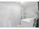 Well-lit laundry room features a full-size washer, dryer, and space saving hanger rack at 10521 W Ross Ave, Peoria, AZ 85382