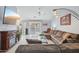 Open-concept living room with tile floors, a fireplace, and a view of the pool area at 10521 W Ross Ave, Peoria, AZ 85382