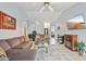 Inviting living room with a fireplace, tile floors, comfortable furniture, and a TV at 10521 W Ross Ave, Peoria, AZ 85382
