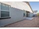 Spacious backyard showcasing the exterior of the home with a sliding glass door at 1057 S 151St Ln, Goodyear, AZ 85338