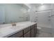 Bright bathroom featuring a modern vanity with a large mirror and a shower-tub combination at 1057 S 151St Ln, Goodyear, AZ 85338