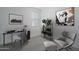 A bright bedroom showcasing a desk, chair, shelving unit, and plants at 1057 S 151St Ln, Goodyear, AZ 85338