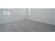 Bright, spacious bedroom features soft gray carpet, white walls and bright natural light at 1057 S 151St Ln, Goodyear, AZ 85338