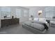 Neutral bedroom featuring carpeting, dresser, lamp, decor, and a queen size bed at 1057 S 151St Ln, Goodyear, AZ 85338