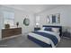 Stylishly staged bedroom with a blue bed set, matching side tables, and decor creating a relaxing atmosphere at 1057 S 151St Ln, Goodyear, AZ 85338