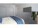 A bedroom with a blue comforter and tv, creating a cozy and modern living space at 1057 S 151St Ln, Goodyear, AZ 85338