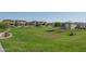 Spacious community park with lush green grass and mature trees, creating a serene environment for recreation and relaxation at 1057 S 151St Ln, Goodyear, AZ 85338