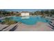 Inviting community pool with clear blue water, surrounded by well-maintained landscaping and comfortable seating areas at 1057 S 151St Ln, Goodyear, AZ 85338