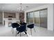 Inviting dining area adjacent to the kitchen, featuring a modern chandelier and sliding glass doors at 1057 S 151St Ln, Goodyear, AZ 85338