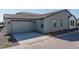 Spacious two-car garage with a modern exterior design, enhancing the home's functionality and aesthetic at 1057 S 151St Ln, Goodyear, AZ 85338