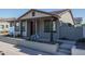 Charming single-story home featuring a covered front porch with classic architectural details and a professionally landscaped yard at 1057 S 151St Ln, Goodyear, AZ 85338