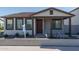 Charming single-story home with a well-manicured front yard and covered porch, creating inviting curb appeal at 1057 S 151St Ln, Goodyear, AZ 85338