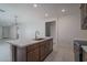 Kitchen with stainless steel appliances, central island, and tiled floors at 1057 S 151St Ln, Goodyear, AZ 85338