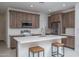 Well-lit kitchen featuring a center island, stainless steel appliances and shaker cabinets at 1057 S 151St Ln, Goodyear, AZ 85338