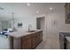Open kitchen with stainless steel appliances, central island, and easy access to living spaces at 1057 S 151St Ln, Goodyear, AZ 85338