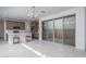Open-concept kitchen with sleek appliances, a center island, and sliding glass doors to the outdoors at 1057 S 151St Ln, Goodyear, AZ 85338