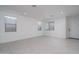 Spacious living room featuring tile flooring, recessed lighting, and ample natural light from large windows at 1057 S 151St Ln, Goodyear, AZ 85338