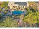 Stunning aerial view of a house with a private pool and solar panels on the roof at 11255 S San Adrian Ln, Goodyear, AZ 85338