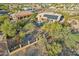 Aerial view of a backyard with a large swimming pool, patio, and lush desert landscaping at 11255 S San Adrian Ln, Goodyear, AZ 85338