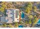 Aerial view of a home showcasing solar panels, a pool, and manicured landscaping at 11255 S San Adrian Ln, Goodyear, AZ 85338