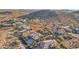 Great aerial view of a home and neighborhood showing community pools, desert landscaping, and mountain backdrop at 11255 S San Adrian Ln, Goodyear, AZ 85338