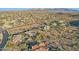 Aerial shot of houses with pools, solar panels and desert landscaping surrounded by natural landscape at 11255 S San Adrian Ln, Goodyear, AZ 85338
