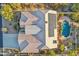 Aerial view showcasing a large home with a solar panel roof and freeform pool at 11255 S San Adrian Ln, Goodyear, AZ 85338