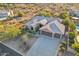 Aerial view of home showcasing tile roof, desert landscaping, and an attached three-car garage at 11255 S San Adrian Ln, Goodyear, AZ 85338