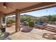 Enjoy mountain views in this backyard featuring a covered patio, pool, and lush desert landscaping at 11255 S San Adrian Ln, Goodyear, AZ 85338