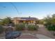 Picturesque backyard view with patio, desert landscaping, solar paneling, and distant mountain views at 11255 S San Adrian Ln, Goodyear, AZ 85338