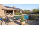 Inviting pool area with a solar panel roof, perfect for outdoor living and energy efficiency at 11255 S San Adrian Ln, Goodyear, AZ 85338
