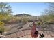 The backyard features desert landscaping, a view of the mountain, and wrought iron fence at 11255 S San Adrian Ln, Goodyear, AZ 85338