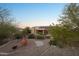 Spacious backyard with brick patio, built-in barbecue, desert landscaping, and a charming desert view at 11255 S San Adrian Ln, Goodyear, AZ 85338