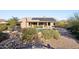 View of backyard pool, solar panels, with desert landscaping and outdoor seating area at 11255 S San Adrian Ln, Goodyear, AZ 85338