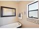 Cozy bathroom featuring a classic clawfoot tub, vintage decor, and a bright window at 11255 S San Adrian Ln, Goodyear, AZ 85338