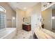 Bright bathroom featuring a soaking tub, dual vanities, and a separate shower at 11255 S San Adrian Ln, Goodyear, AZ 85338
