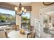 Charming breakfast nook featuring views of the pool and lush backyard landscaping at 11255 S San Adrian Ln, Goodyear, AZ 85338