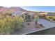 Charming single-story home with well-manicured desert landscaping and attached three-car garage at 11255 S San Adrian Ln, Goodyear, AZ 85338