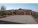 Home's exterior elevation showcasing its three-car garage and desert landscaping at 11255 S San Adrian Ln, Goodyear, AZ 85338
