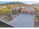 Beautiful home featuring a spacious driveway and desert landscaping at 11255 S San Adrian Ln, Goodyear, AZ 85338
