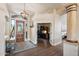 Grand foyer featuring wood floors, high ceilings, and an open office area at 11255 S San Adrian Ln, Goodyear, AZ 85338