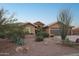Home's front yard showcasing desert landscaping with lush succulent accents and bushes at 11255 S San Adrian Ln, Goodyear, AZ 85338