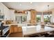 Well-lit kitchen boasting stainless steel appliances, farmhouse sink, and center island with breakfast bar at 11255 S San Adrian Ln, Goodyear, AZ 85338
