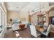 Bright and airy living and dining room featuring a statement chandelier and views of the entryway at 11255 S San Adrian Ln, Goodyear, AZ 85338