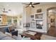 Inviting living space with a fireplace and seamless flow to the breakfast nook and kitchen at 11255 S San Adrian Ln, Goodyear, AZ 85338